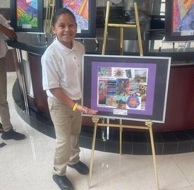 Student standing next to artwork